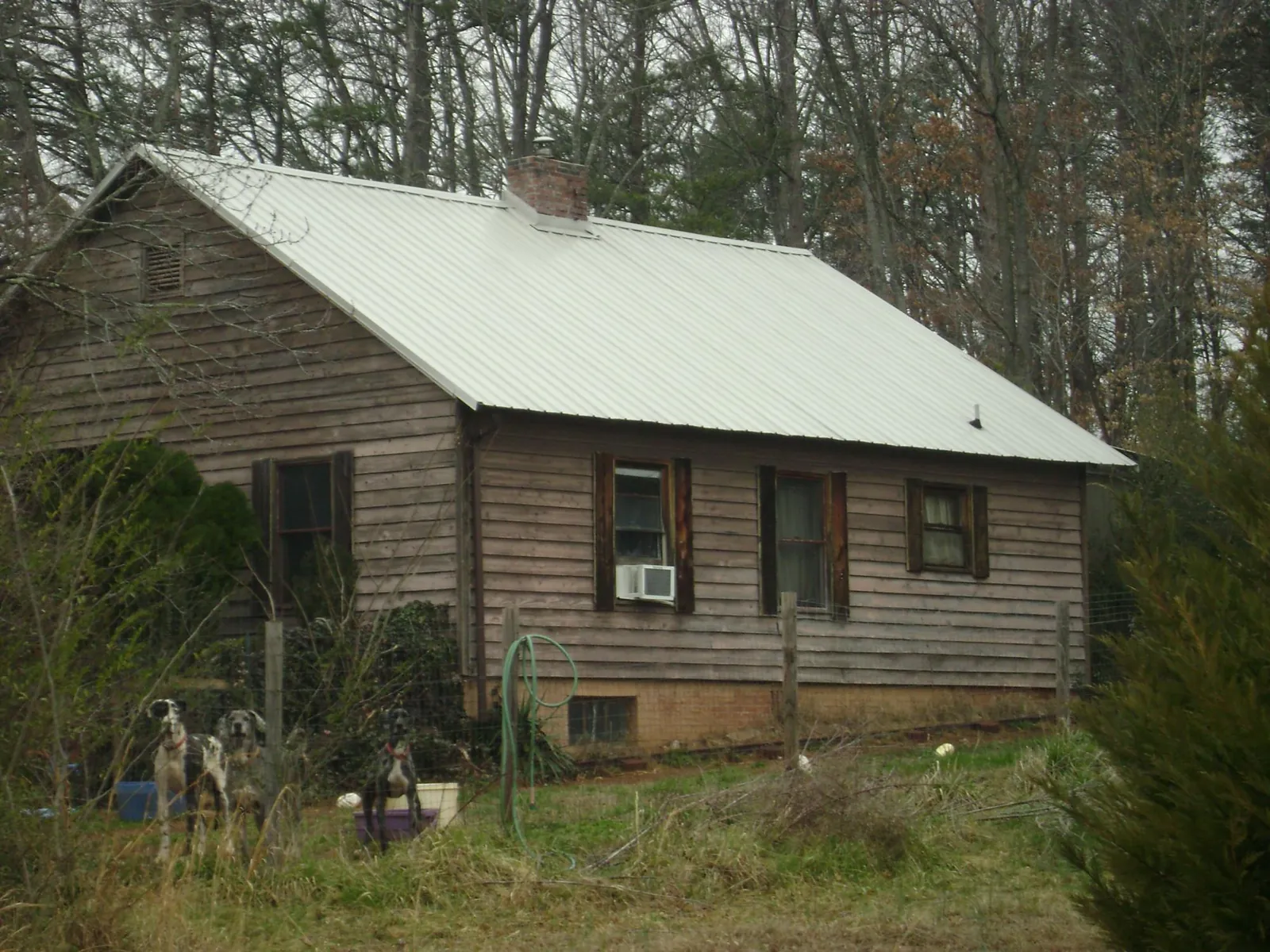 White metal roof on an old wood sided farmhouse, from a Metal Roof Installation job in Rebuck